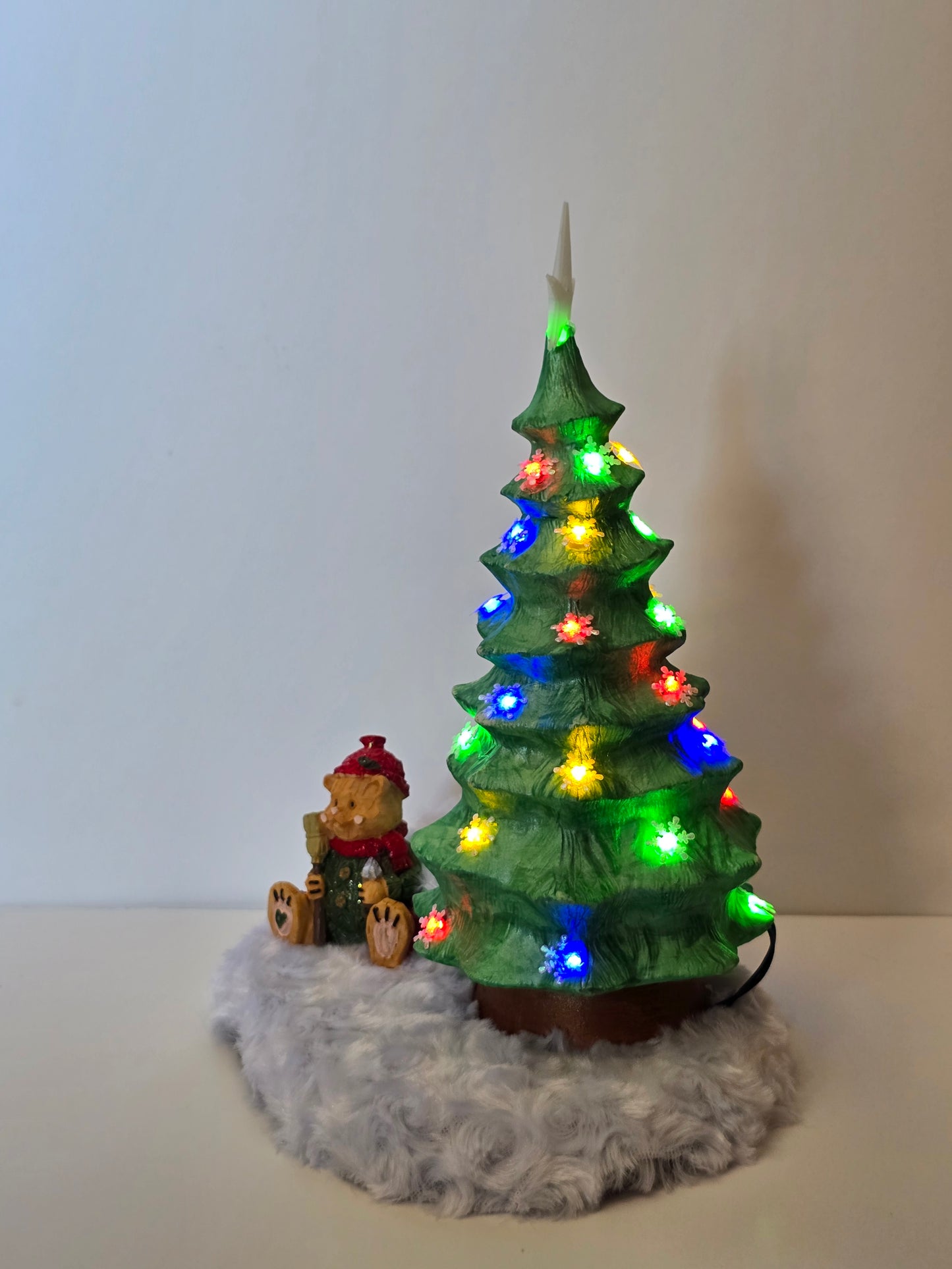 Ceramic Christmas tree with remote colored lights.