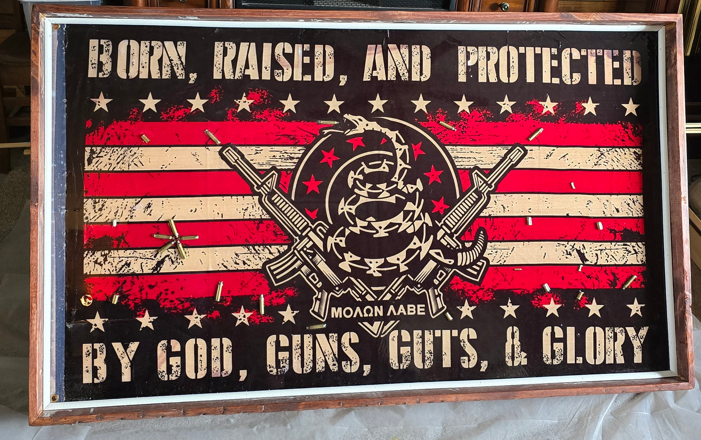 Born, raised, and protected flag in resin and wood.
