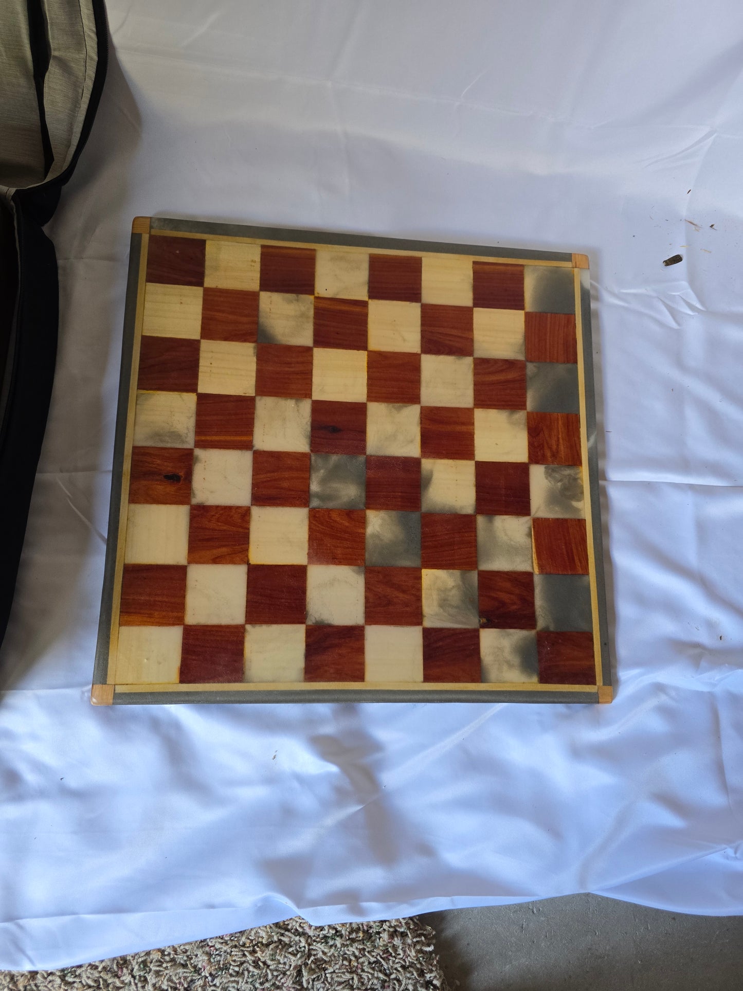 Wood and resin chess set with ceramic pieces. Red and white 18 by 18 inch board.