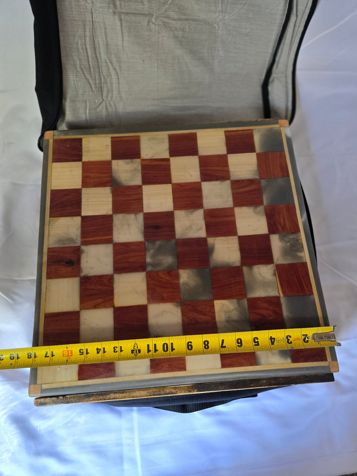 Wood and resin chess set with ceramic pieces. Red and white 18 by 18 inch board.